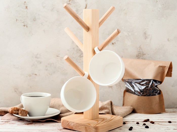 Vertical coffee mug holder with coffee beans.